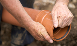 Mike, one of our Littleton sewer line repair pros, is fitting a new pipe in place