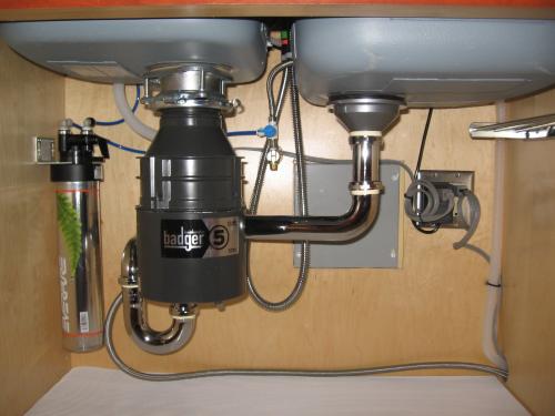 Plumbers install garbage disposal