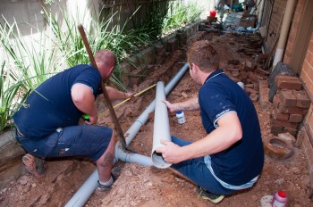 two of our pros are working on a trenchless sewer repair in Littleton